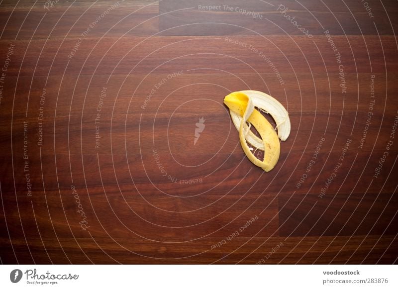 Einen Fehler oder Ausrutscher machen Frucht gelb Bananenschale Etage Oberfläche Holz unbedeutend sich[Akk] schälen Unfall Risiko potenzielle Gefahr Haut Unglück