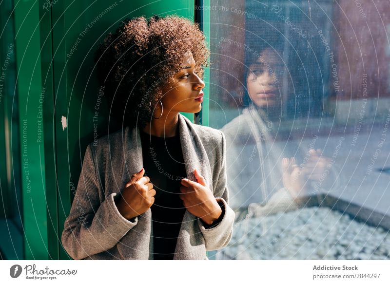 Trendiges schwarzes Modell im Fensterdesign Frau Stil besinnlich genießen feminin elegant Ausschau haltend Afrikanisch Beautyfotografie Körperhaltung Straße