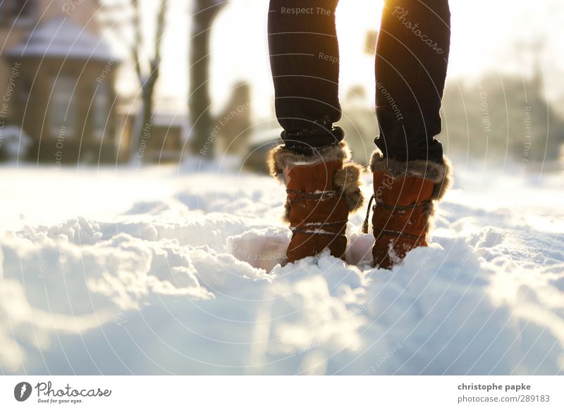 Winterzauber Schnee Winterurlaub feminin Beine Fuß 1 Mensch Schönes Wetter Eis Frost Jeanshose Fell Schuhe Stiefel Wanderschuhe Erholung frieren gehen stehen