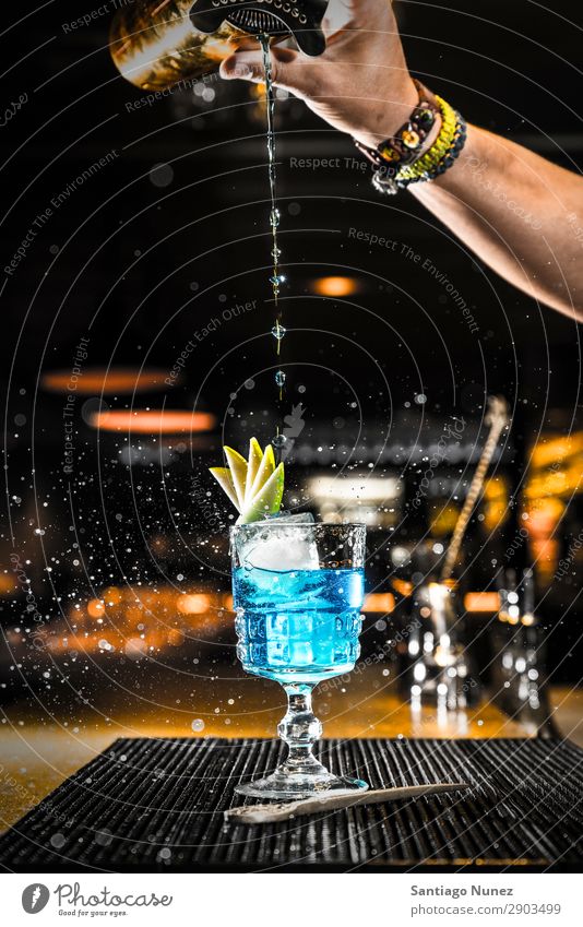 Barkeeper, der einen Cocktail in ein Glas gießt. Schüttler Martini Gießen Portion Boston Getränk trinken Alkohol Gin Hand Nachtclub Vodka Hintergrundbild