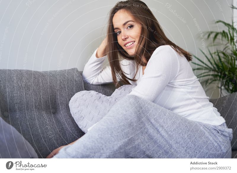 Lächelnde Frau auf der Couch sitzend Porträt heimwärts Kanapee aussruhen Sofa Erholung Glück Jugendliche attraktiv Lautstärke Wissen Lifestyle Freizeit & Hobby