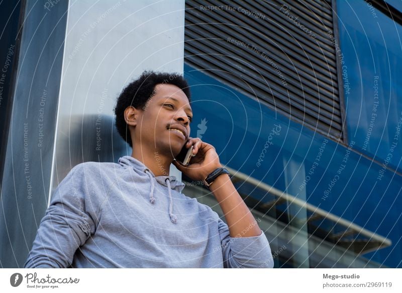 Junger Lateinamerikaner, der draußen mit dem Handy telefoniert. Lifestyle Stil Glück Gesicht Business sprechen Telefon PDA Technik & Technologie Mensch Mann