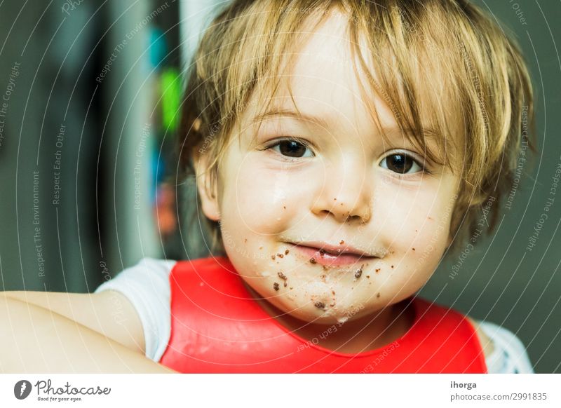 Porträt bezauberndes Kind isst Schokolade Biskuitkuchen Attribut Baby Hintergrund Lätzchen Junge braun Kuchen Bonbon Kindheit schoko niedlich lecker wüst