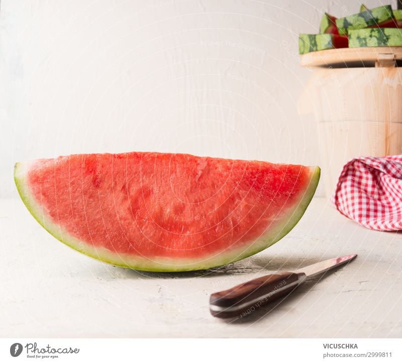 Ein Stück Wassermelone mit Messer Lebensmittel Frucht Dessert Ernährung Bioprodukte Stil Gesunde Ernährung Sommer Design Snack Hintergrundbild Tisch weiß