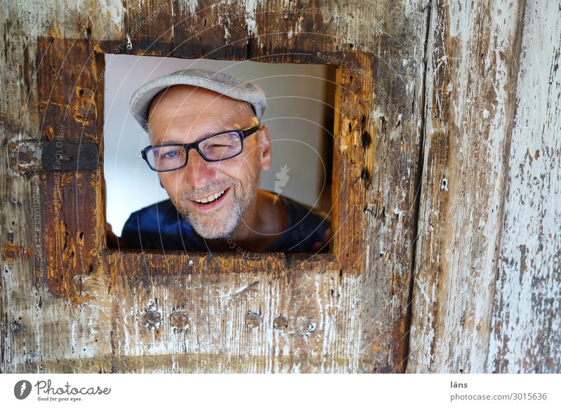 lustiges männliches Porträt im Holzrahmen Mensch maskulin Leben 1 Mauer Wand Brille Mütze beobachten Lächeln Blick Freundlichkeit Fröhlichkeit Glück natürlich
