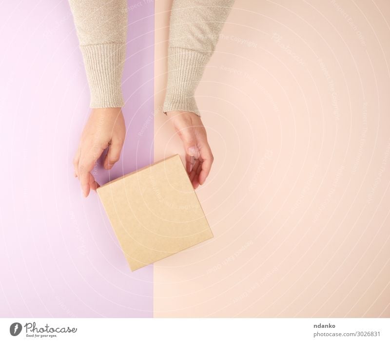 Mädchen hält eine braune, quadratische Schachtel. Dekoration & Verzierung Feste & Feiern Hochzeit Geburtstag Frau Erwachsene Hand Papier Paket Herz festhalten