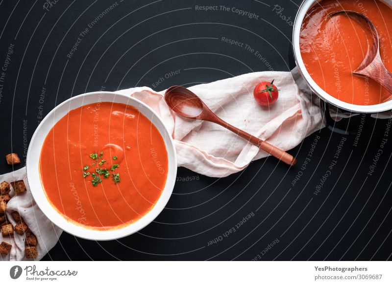 Tomatensuppe auf schwarzem Tisch. Gesunde hausgemachte Suppe Gemüse Eintopf Kräuter & Gewürze Ernährung Mittagessen Abendessen Vegetarische Ernährung Diät