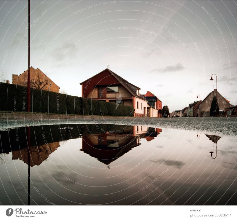 Auf dem Asphalt Landkreis Teltow-Fläming Deutschland Dorf bevölkert Haus Mauer Wand Mast Laternenpfahl Straßenbeleuchtung Pfütze trist ruhig Idylle Farbfoto