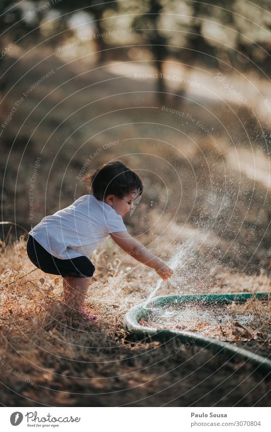 Kind spielt mit dem Wasserschlauch Lifestyle Mensch Kleinkind Mädchen 1 1-3 Jahre Sommer berühren genießen Spielen Fröhlichkeit Glück lustig Neugier wild