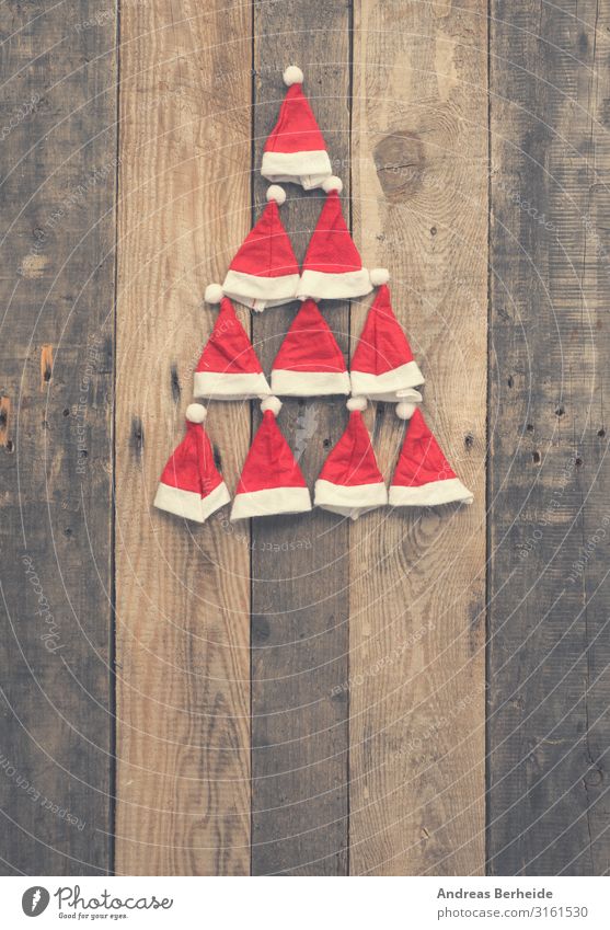 Christmas tree shape made with hats of Santa Stil Winter Weihnachten & Advent Hut Mütze Holz Ornament Tradition Weihnachtsmann red rustic plank wooden nobody