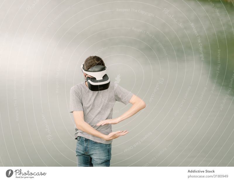 Junge Teenager mit Virtual-Reality-Brille im Freien virtuell Realität Brillenträger VR Jugendliche Natur Headset Technik & Technologie Spielen Zukunft 3d