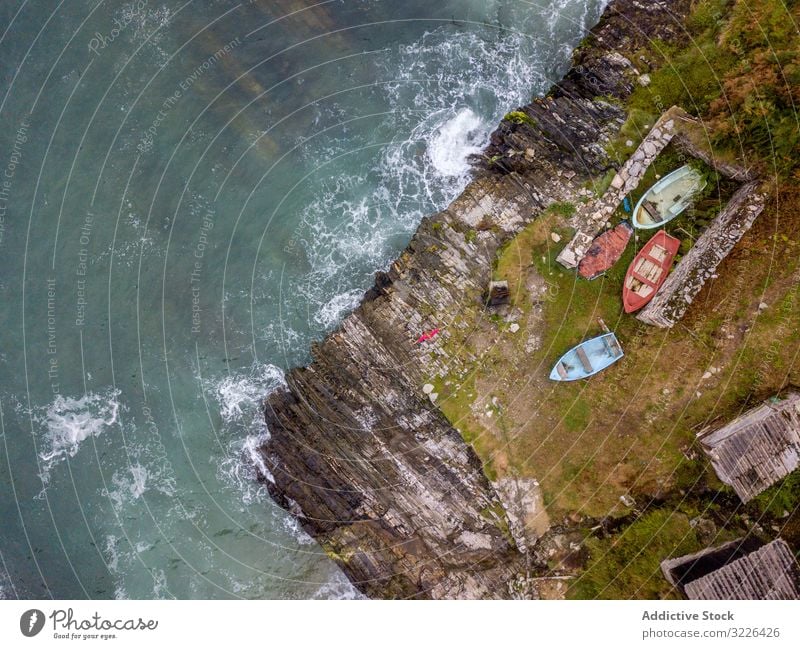 Boote auf einem kleinen Teil der Meeresküste werden von schäumenden Wellen umspült Seeküste Wasser Küste winken Urlaub Meeresufer Natur reisen Landschaft grün