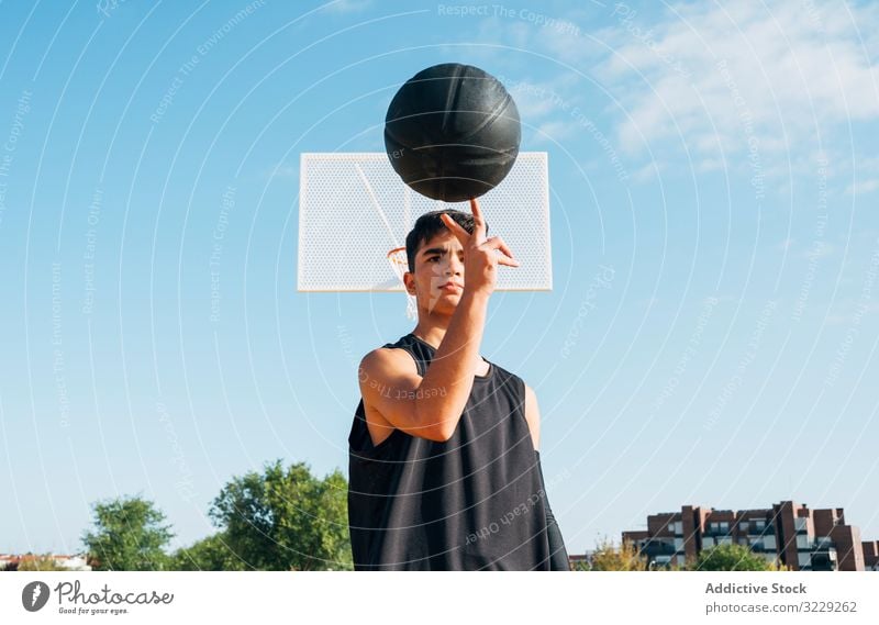 Junger Mann spielt auf gelbem Basketballfeld im Freien. Athlet Konkurrenz Sportgerät Erwachsener Erholung Aktion Ball Porträt aktiv Aktivität Asphalt sportlich