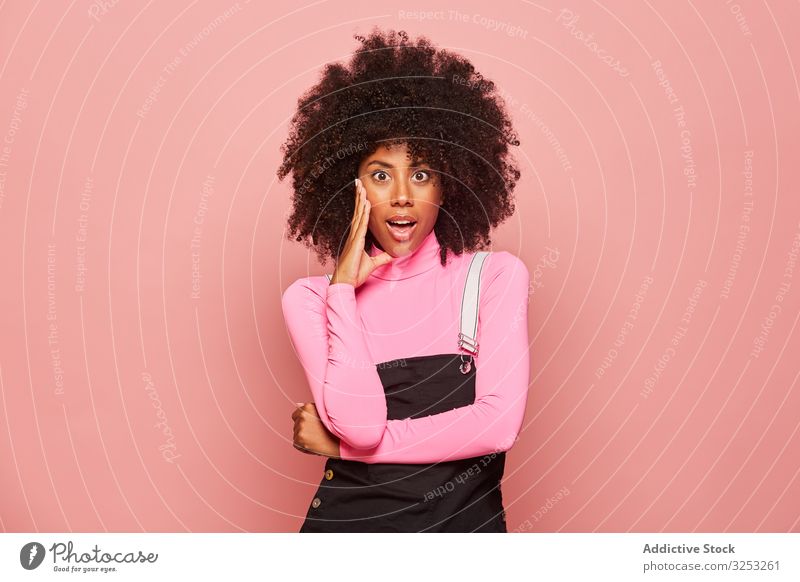 Geschockte afroamerikanische Frau schaut in die Kamera überrascht erstaunt schockiert jung lässig rosa Afroamerikaner schwarz stehen ethnisch Rollkragenpulli