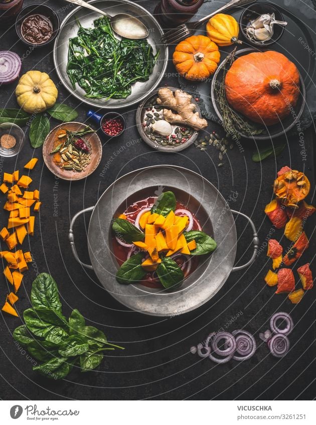 Cooking of seasonal vegetarian meals for autumn and winter Winter Erntedankfest Essen cooking pumpkin spinach ginger onion top view healthy food concept above