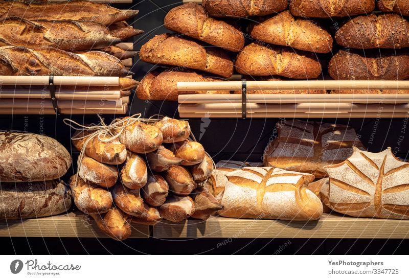 Brotsortiment in Holzregalen der Bäckerei. Brotgeschäft Lebensmittel Teigwaren Backwaren Brötchen Ernährung kaufen Gesunde Ernährung Tradition Baguette