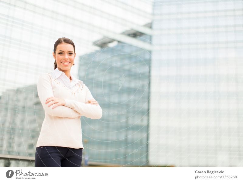 Junge Geschäftsfrau vor dem Bürogebäude Lifestyle Stil Glück schön Erfolg Business Karriere Mensch Junge Frau Jugendliche Erwachsene Gebäude Lächeln stehen