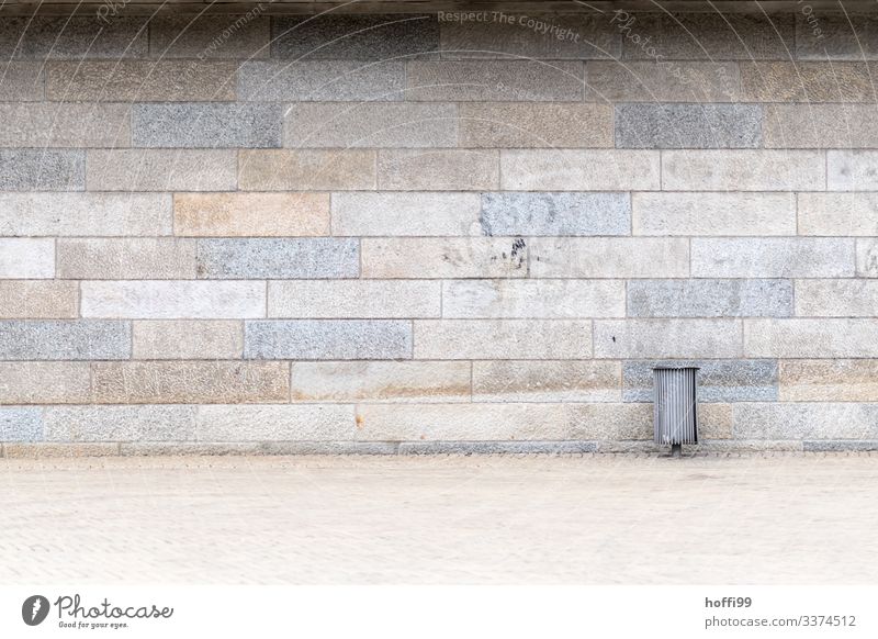 Mülleimer vor Sandsteinmauer mit verblassendem Graffito diagonal Wand Baustein minimalistisch Stufenordnung taumeln Treppe Treppenansatz Steinwand Ordnung