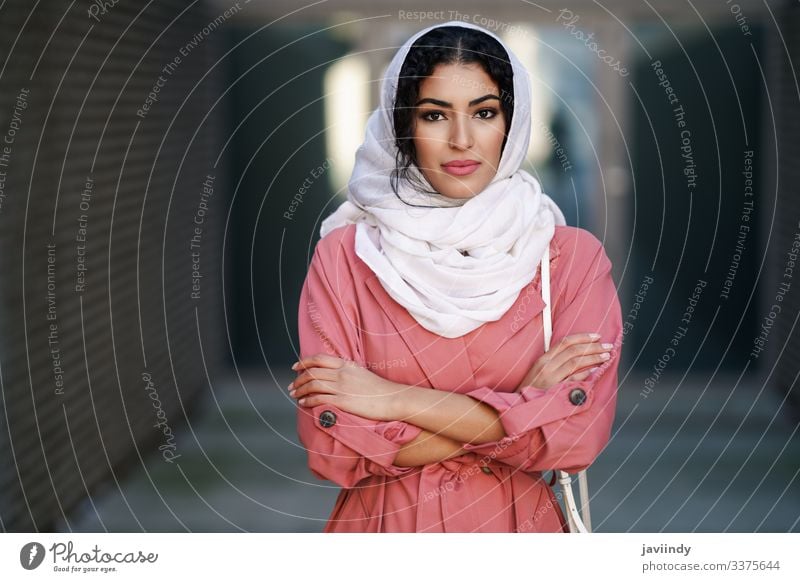 Junge muslimische Frau mit Hijab-Kopftuch beim Spaziergang durch die Innenstadt. arabisch jung Schal Tourist attraktiv schön urban Großstadt Lifestyle Straße