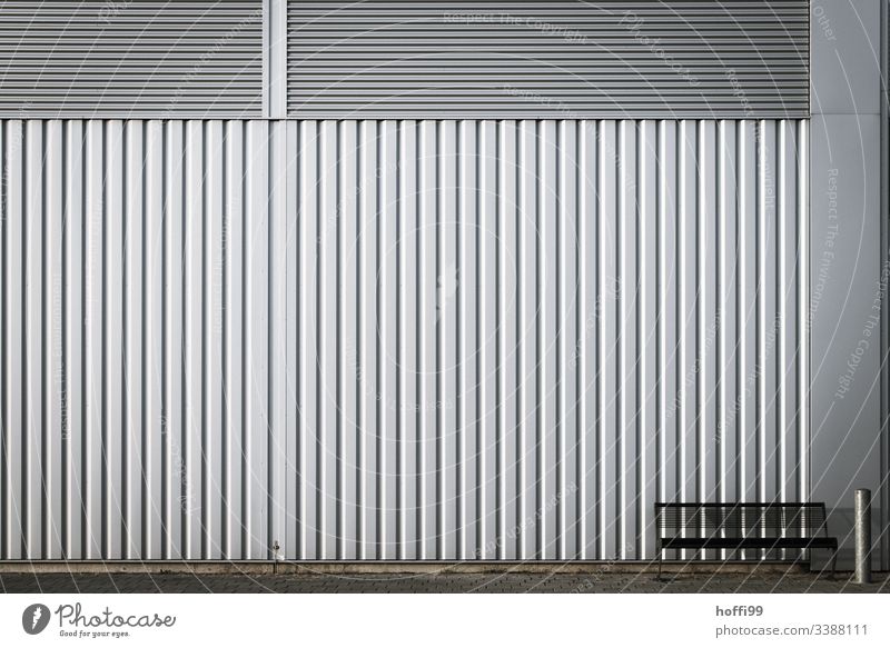 Bank mit Aschenbecher vor einer Metallwand - nehmen Sie Platz Industriebetrieb Wand Stahl Linie sitzen Mauer Architektur Fassade Strukturen & Formen