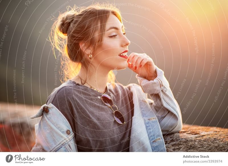 Stilvolle Frau in lässiger Kleidung erfreut sich am Anblick Lächeln genießen Sonne trendy Lifestyle Harmonie Mode ruhen sich[Akk] entspannen Outfit Wochenende