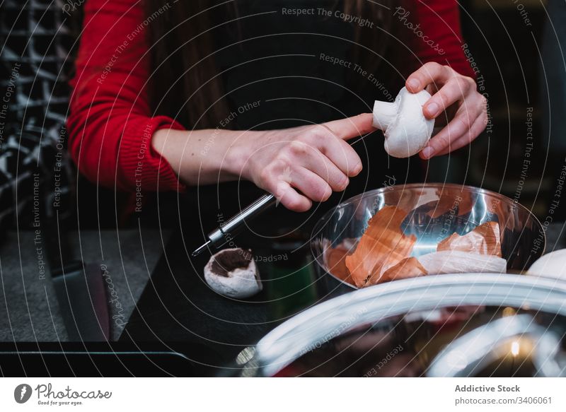 Nutzpflanzenfrau schneidet Pilze über Schüssel Frau geschnitten Küche Kurs Sauberkeit Koch Restaurant Tisch Schalen & Schüsseln Messer vorbereiten Lebensmittel