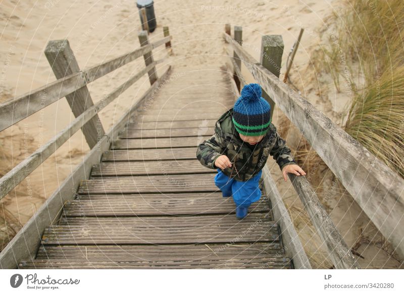 Junge beim Treppensteigen die Treppe hinauf Zukunftsbild Optimismus Kraft Tatkraft Erfolg Karriere Mut Willensstärke Entschlossenheit Gefühle Kinderspiel Leben