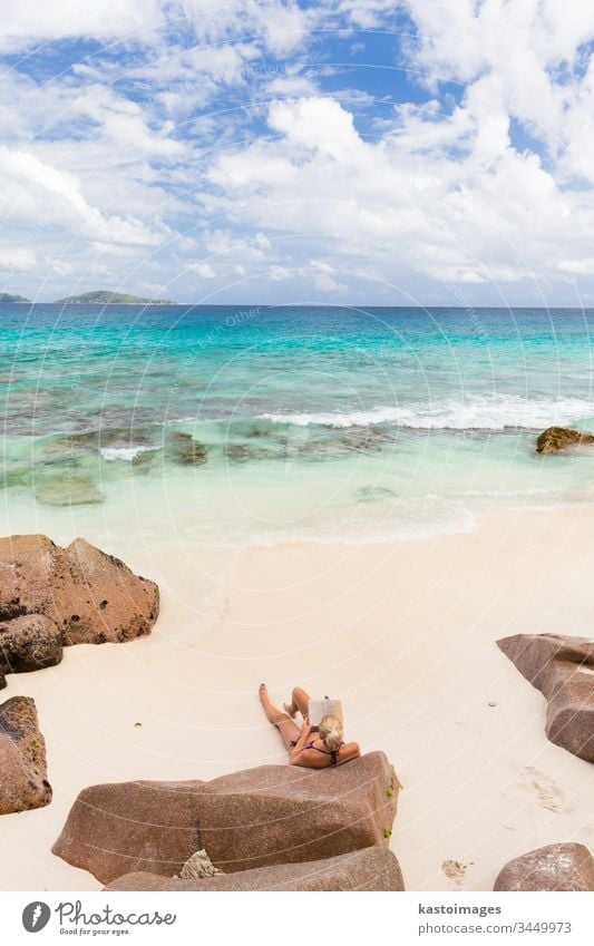 Frau liest Buch über den bildschönen Strand Anse Patates auf der Insel La Digue, Seychellen. reisen lesen Sommer Urlaub Lifestyle Feiertag MEER Sand Resort
