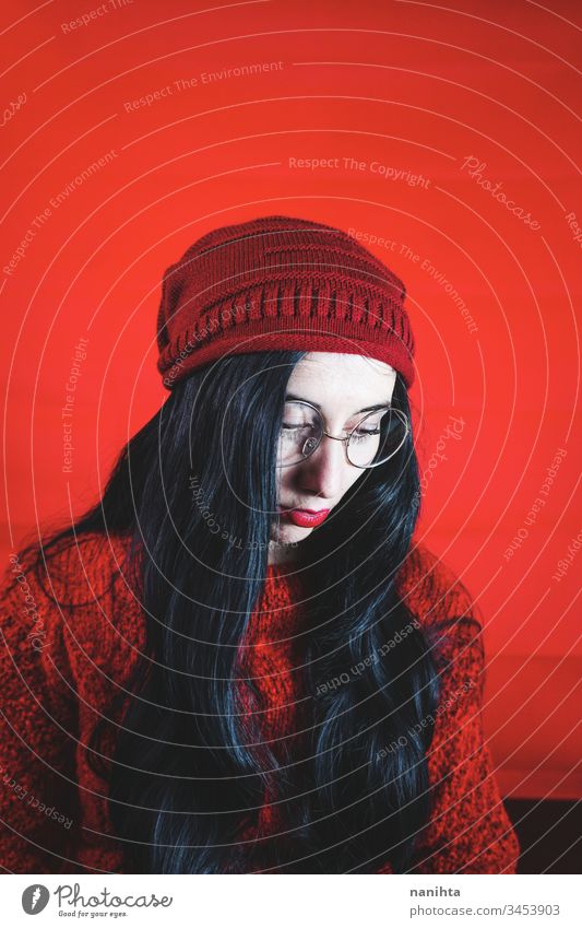 Porträt einer jungen brünetten Frau vor rotem Hintergrund Atelier Streberin nerdig Brille hübsch Gesicht anders cool schwarz Stimmung Ausdruck Emotion retro