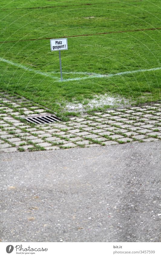 Platz gesperrt, geschrieben auf Schild in der Ecke von einem Sportplatz mit grünem Rasen, neben einer Straße. geschlossen Wort Buchstaben Vorsicht Hinweisschild
