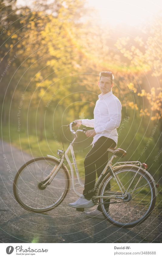 Mann fährt mit dem Fahrrad durch die Natur und macht eine