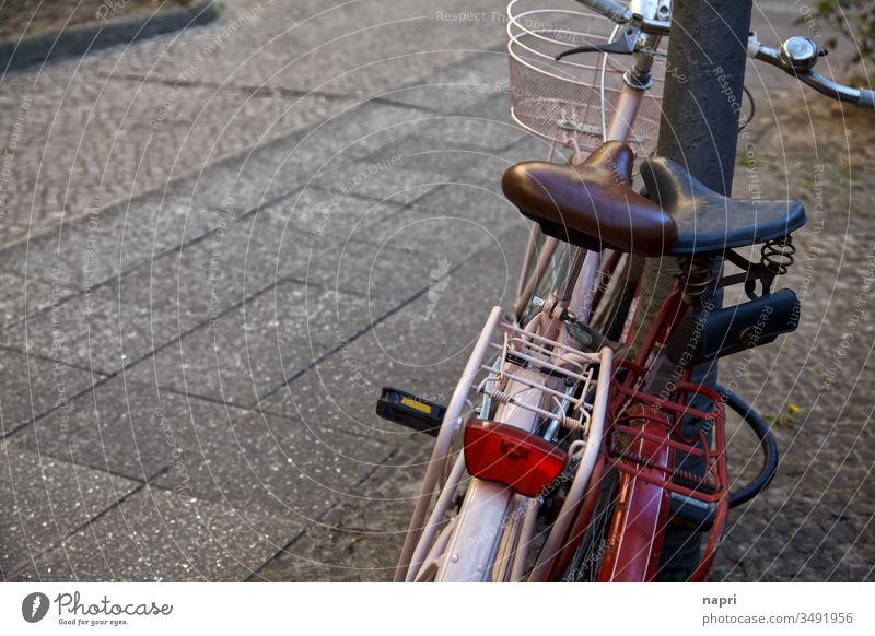 Zwei Fahrräder stehen eng beieinander an einen Laternenmast gelehnt. Fahrrad zwei Fahrradfahren Ausflug anlehnen Zusammensein Zweisamkeit Vintage retro alt