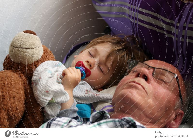Opa, Enkel und der Teddy machen gemeinsam Mittagsschlaf Senior Mann Kind Kleinkind Teddybär schlafen ruhen miteinander geschlossene Augen Brille Schnuller