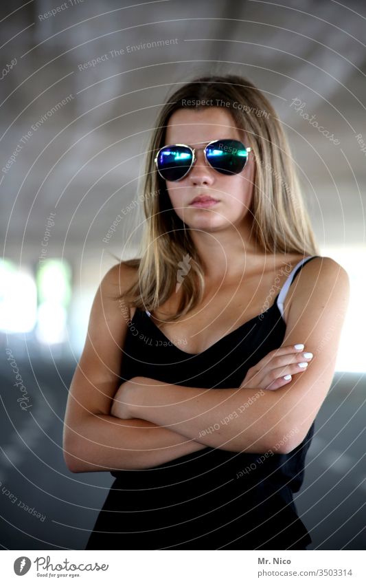 Portrait mit Sonnenbrille selbstbewußt Coolness Lifestyle Porträt Blick Haare & Frisuren Accessoire Mode schön langhaarig schwarz verschränkte Arme