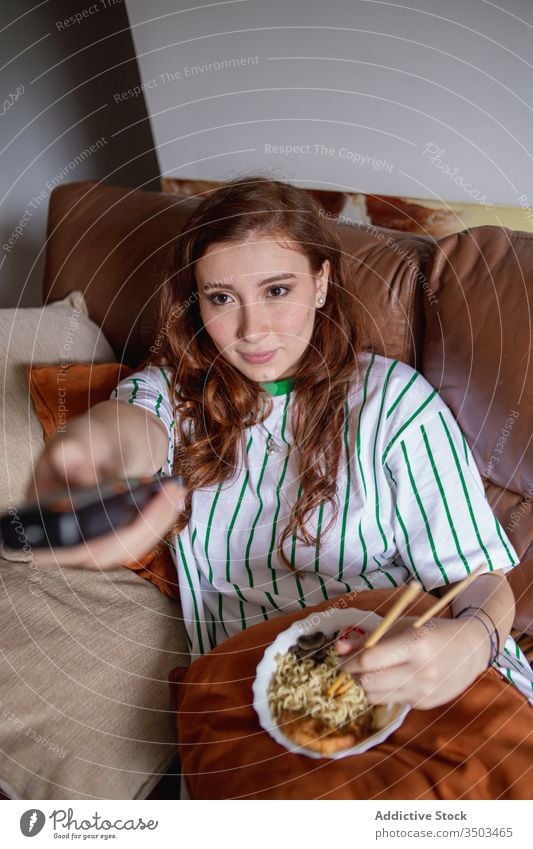 Junge Frau isst Nudeln und sieht fern Ramen essen zuschauen FERNSEHER heimwärts Mittagessen jung ruhen Japanisch Sofa Filmmaterial Wandel & Veränderung Kanal
