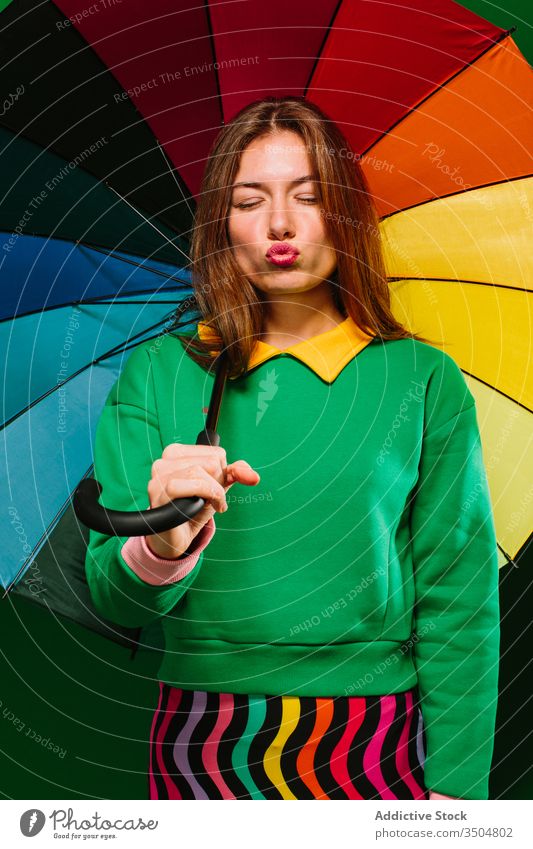Junge Frau mit buntem Regenschirm im Studio farbenfroh Farbe Stil hell lebhaft jung mehrfarbig Mode Model urban selbstbewusst Accessoire trendy Individualität