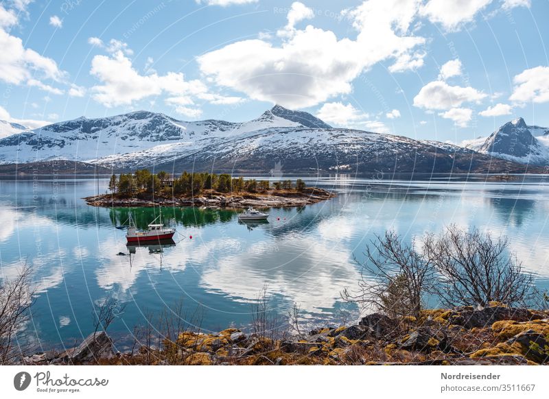 Landschaft mit Insel und Fischerboot auf den Lofoten im Frühling insel küste lofoten meer wasser fischerboot fjord felsen schnee schären norwegen ozean stimmung
