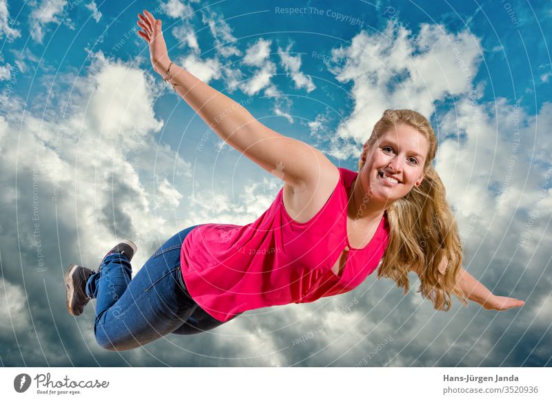 Junges Mädchen fliegt lachend hoch in Wolken frau himmel springen freudig jung blau sommer spaß fröhlichkeit freude freiheit leute kind ausserhalb energie aktiv