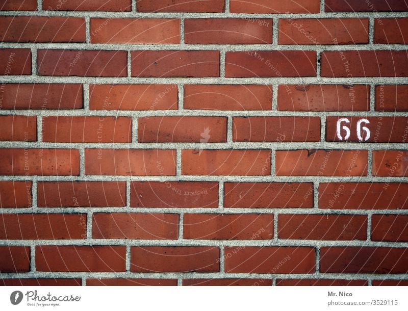 66 Hausnummer Ziffern & Zahlen Zeichen Mauer Wand sechsundsechzig Backsteinwand Backsteinmauer rot markierung linien oldstyle orientierung information