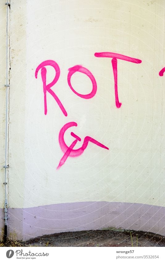 Hammer, Sichel und das Wort ROT mit roter Farbe auf eine beige Wand gesprayt Schrift Sprühfarbe sprühen Graffiti sprayen Schriftzeichen Menschenleer Tag