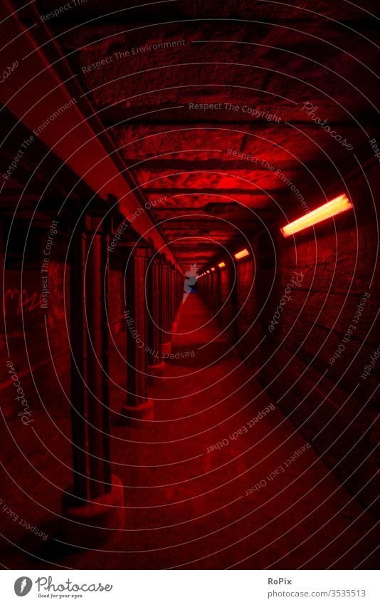 Rot beleuchteter Tunnel im Landschaftspark nord. crossing Unterführung Stahlwerk Technik Infrastruktur Stadt Beleuchtung Kontrast urban Säulen Fluchtweg
