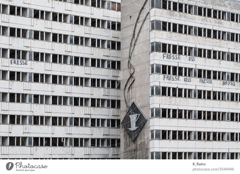 alte Leuchtreklame an einem DDR-Plattenbau in Berlin berlin fassade leuchtreklame ddr plattenbau deutsch haus zuhause mehrfamilienhaus blöcke kaputt wohnen