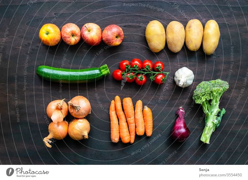 Frisches regionales Gemüse in einer Reihe auf einem braunen Holz Hintergrund, Draufsicht bunt Gemüsekiste Lebensmittel Bioprodukte Vegetarische Ernährung