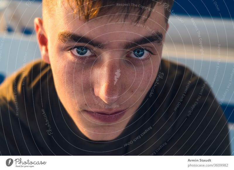 Nahaufnahme Porträt eines lächelnden jungen Mannes Jugendlicher Hintergrund schön Junge offen lässig Kaukasier selbstbewusst cool abgeschnitten dunkel Abend