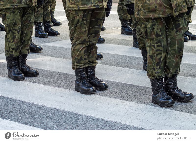 Auf der Straße stehende Soldaten in einer Militäruniform mit Tarnung und schwarzen Militärstiefeln Truppen Springerstiefel Bootcamp Zug Veteranentag Stehen