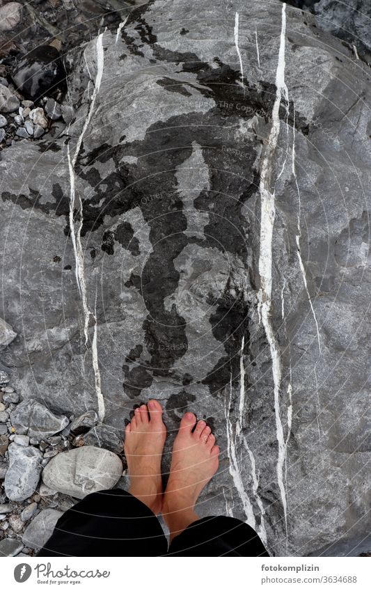 nasse Füße mit Fußabdrücken auf Felsen mit weißen parallelen Linien Flowstone Fußspuren Spurensuche Stein Steine Kieselsteine filtzen Parallelen nebeneinander