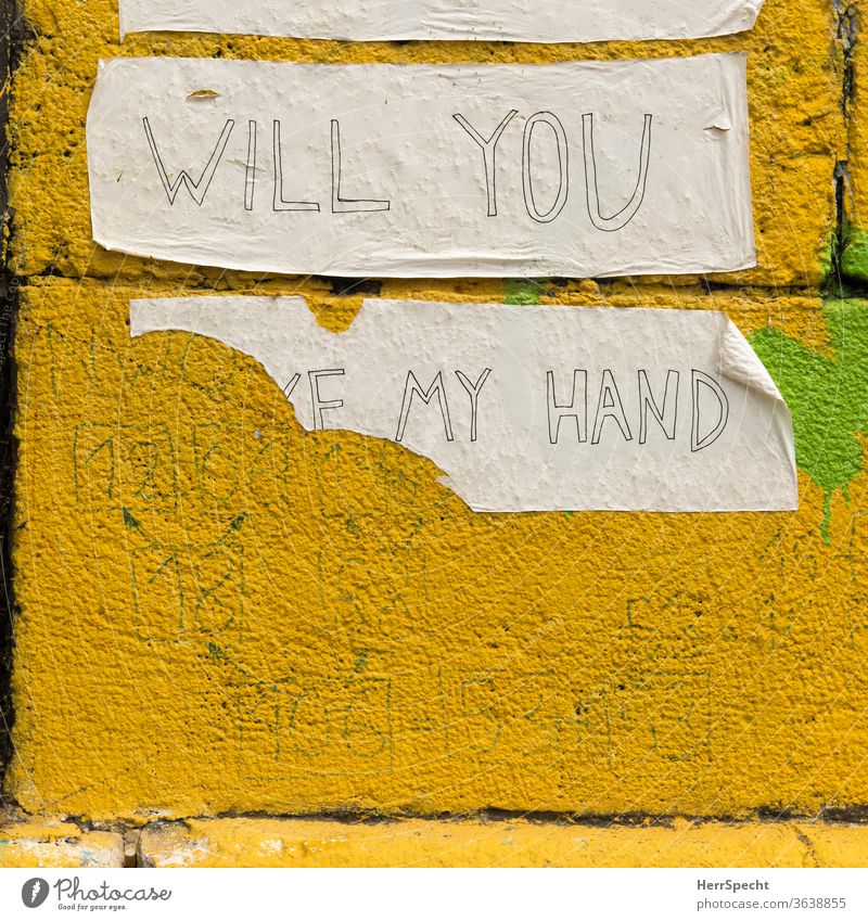 Will you take my hand? Graffiti klebestreifen Händchenhalten Hand Fragen abgerissen aufgeklebt Botschaft Wand Mauer Schriftzeichen gelb unvollständig
