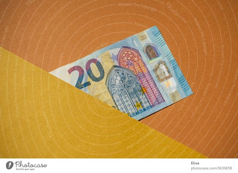 20 Euro Schein. Geldschein. Geld. halb verdeckt Textfreiraum grafisch Kapitalwirtschaft sparen Bargeld einzeln blau gelb orange beige