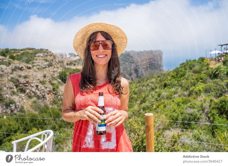 Glückliche Frau mit Bierflasche im Zelt Reisender Lager heiter Resort Sonnenbrille gemütlich Flasche sonnig Freizeit Getränk sich[Akk] entspannen Inhalt froh