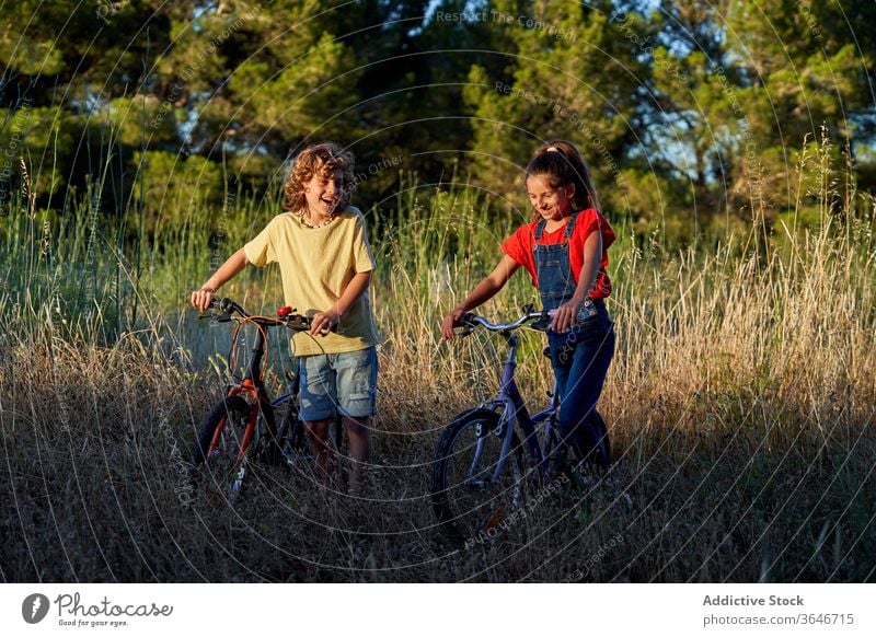 Zehnjähriger Junge und Mädchen radeln durch die Landschaft Fahrradfahren Freude Lächeln Kind Genuss Lifestyle Kinder Spaß outdoorsy Erkundung trainiert.